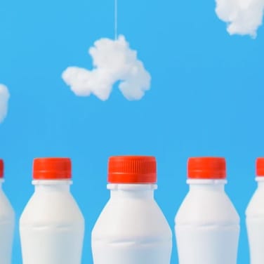 milk bottles on cloudy background