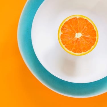 orange slice in a bowl on orange background